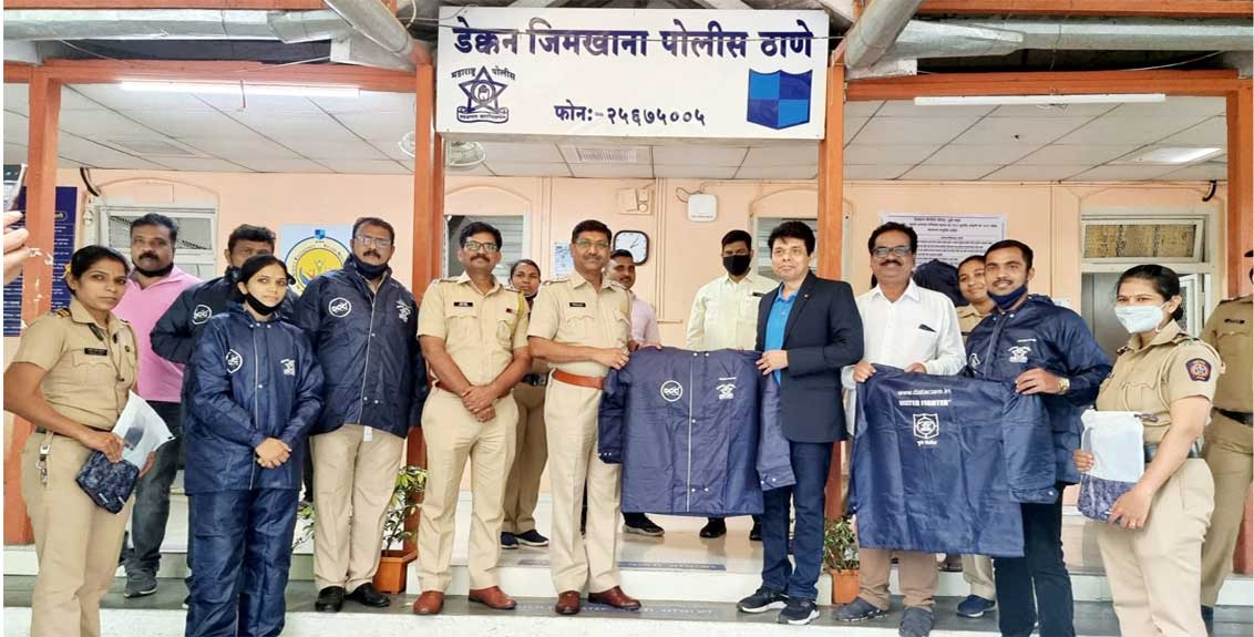 Data Care Corporation distributes raincoats to police at Deccan Police Station
