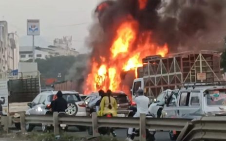 Navale Bridge Pune accident — car trapped between burning containers on Pune-Bengaluru Highway